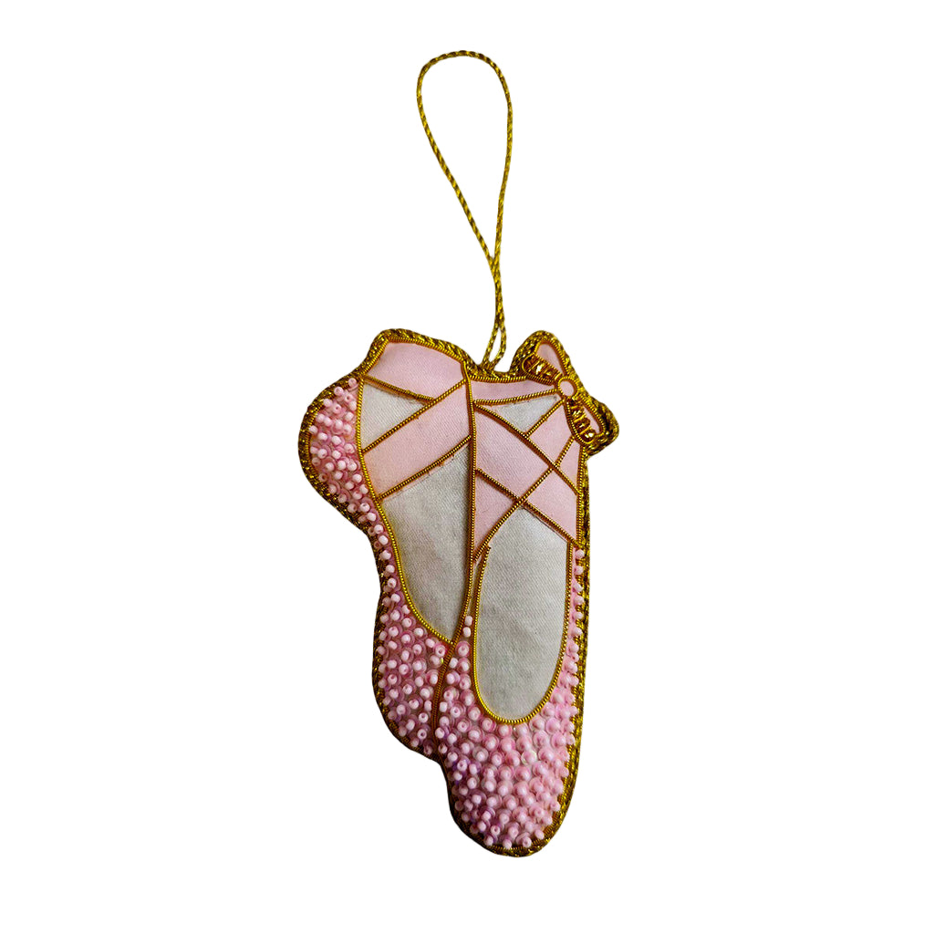 a pink beaded ballet shoe decoration  with gold trim on a white background