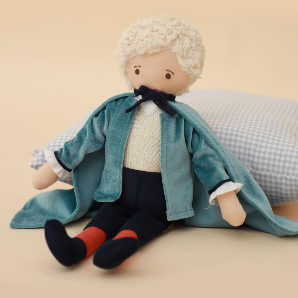 Toy Drosselmeyer ballet doll with a blue coat, cape and white hair on a white background