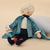 Toy Drosselmeyer ballet doll with a blue coat, cape and white hair on a white background