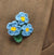 colourful crochet flower brooch on a white background