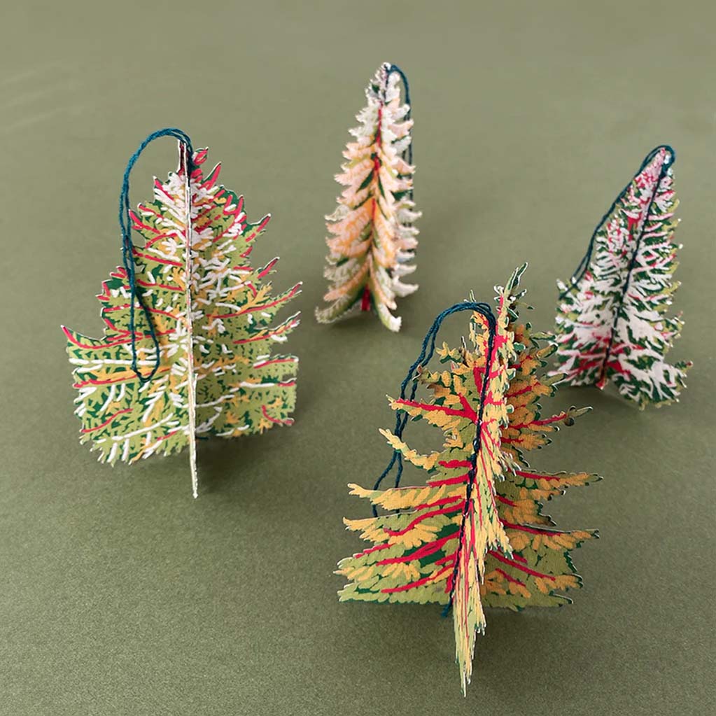 Decorative fur tree paper ornaments with packaging labeled 'East End Press' on a white background