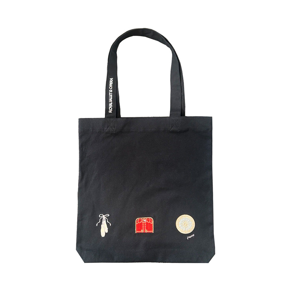 Black tote bag with ballet shoes, the stage and the Auditorium ceiling embroidered on the front with white text foxco on a white background