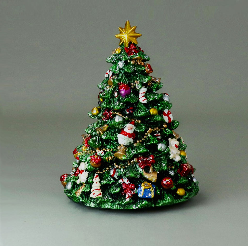 Decorative musical Christmas tree with ornaments and star on top on a gray background
