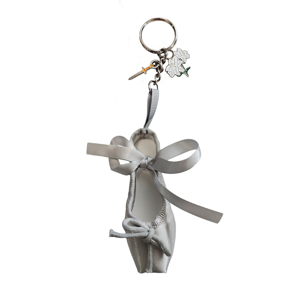  giselle keyring features a silver ballet shoe with a sword and lilies for charms