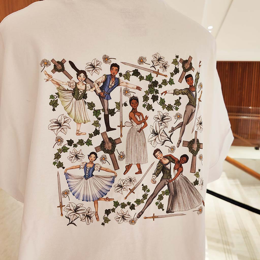 close up of the back of the t-shirt with ballet-themed design featuring dancers and decorative elements.