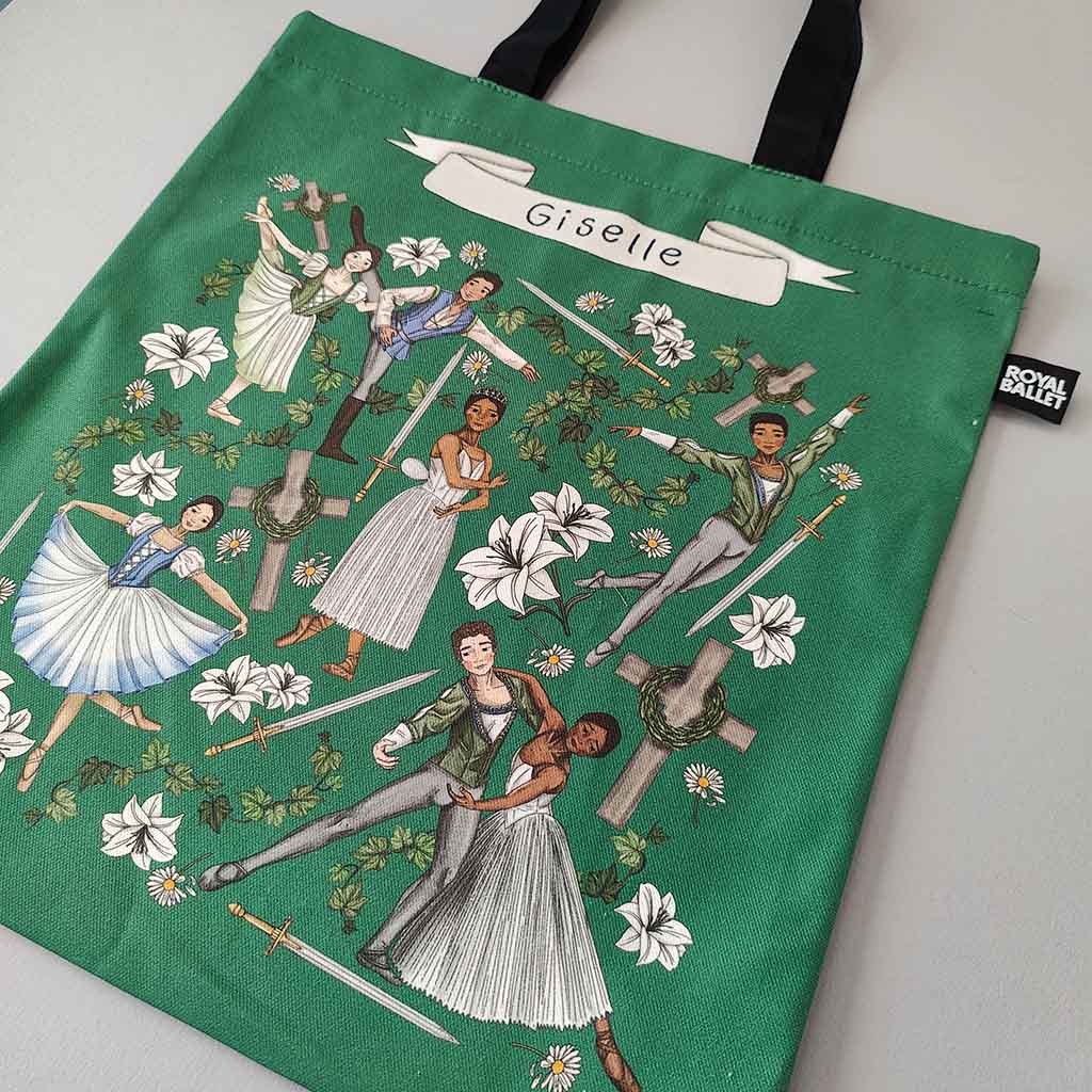 Green tote bag with 'Giselle' ballet design and black handles on a white background