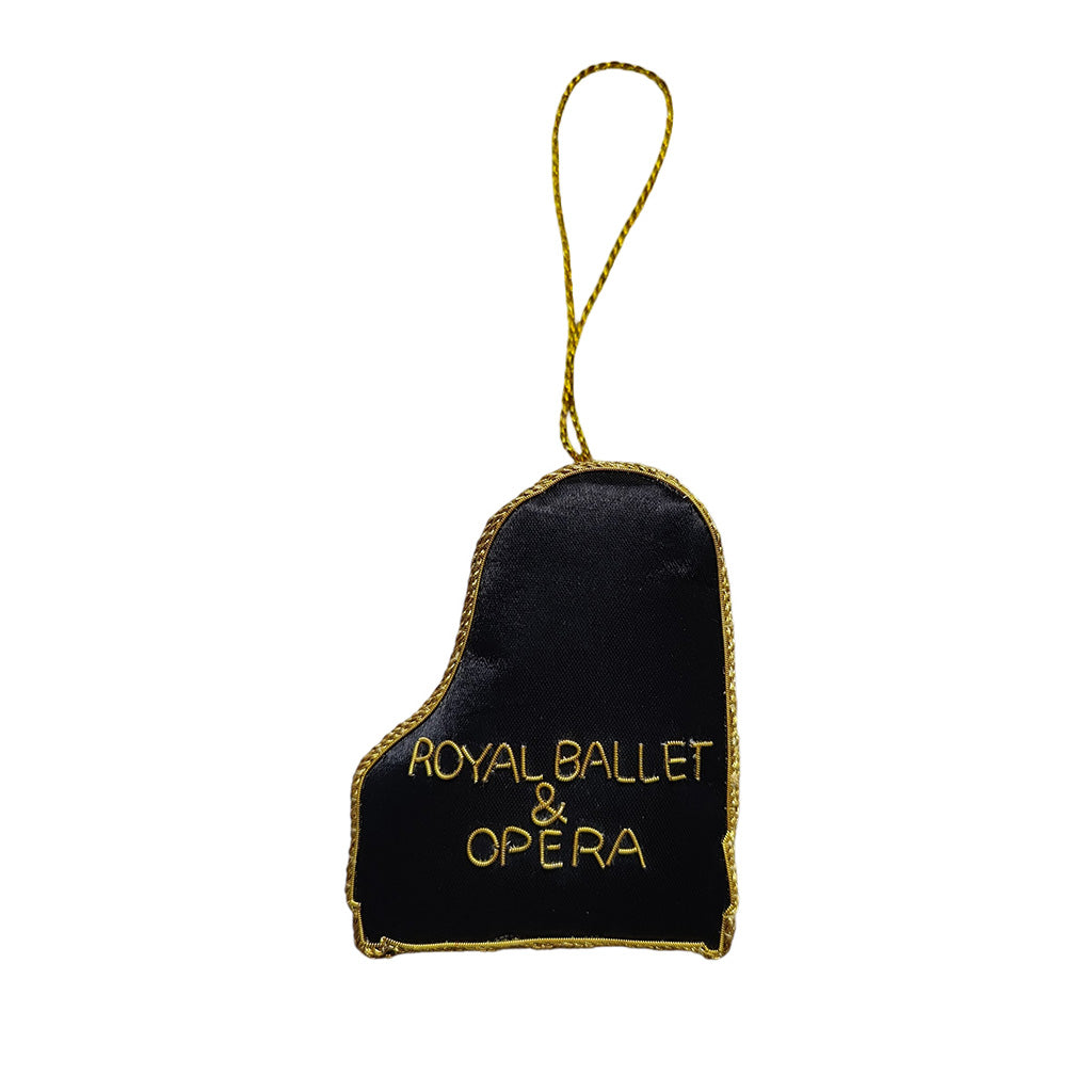 Black piano decoration with 'Royal Ballet &amp; Opera' text on a white background