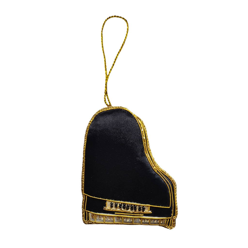Black and gold piano-shaped ornament on a white background