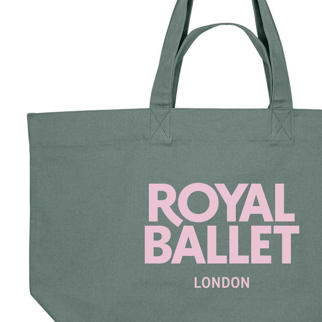 close-up of a green shopper bag with pink text 'Royal Ballet London' on a white background