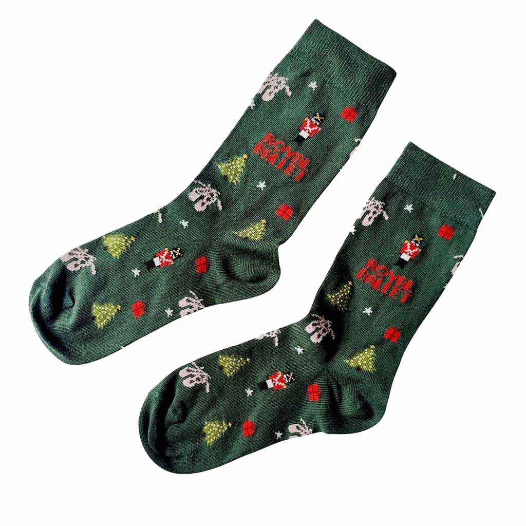Pair of green Nutcracker ballet socks with festive designs on a white background