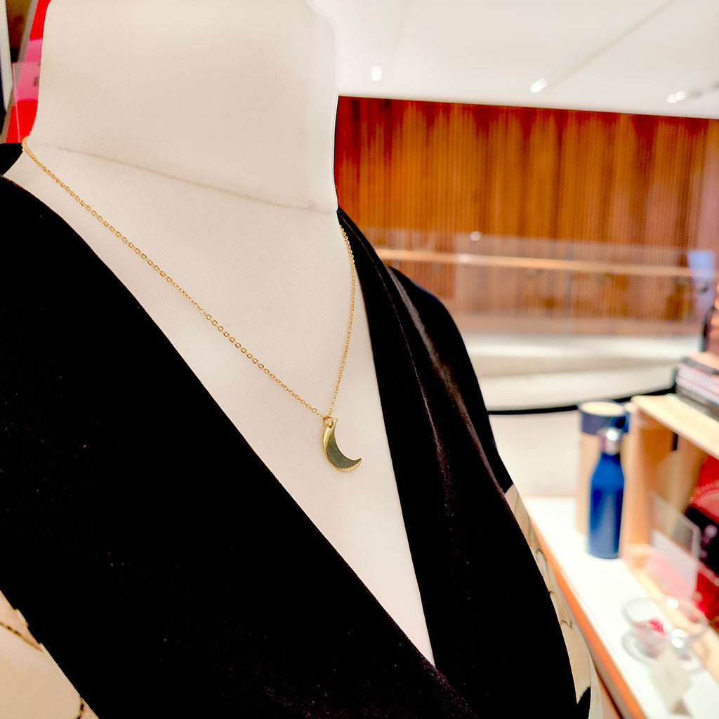 Magic Flute Half Moon Necklace on mannequin in the shop