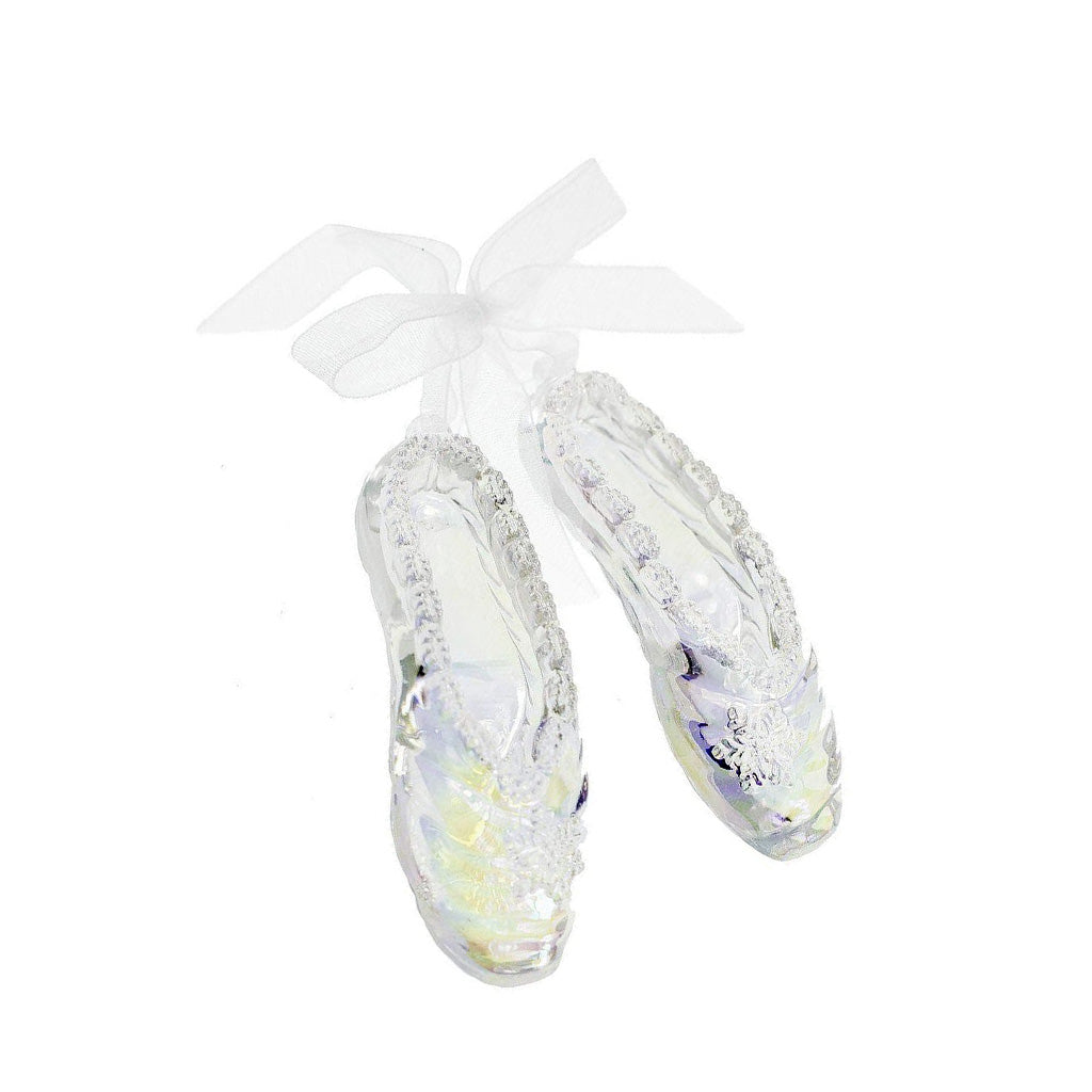 Iridescent acrylic ballet shoe decoration with a bow on a white background