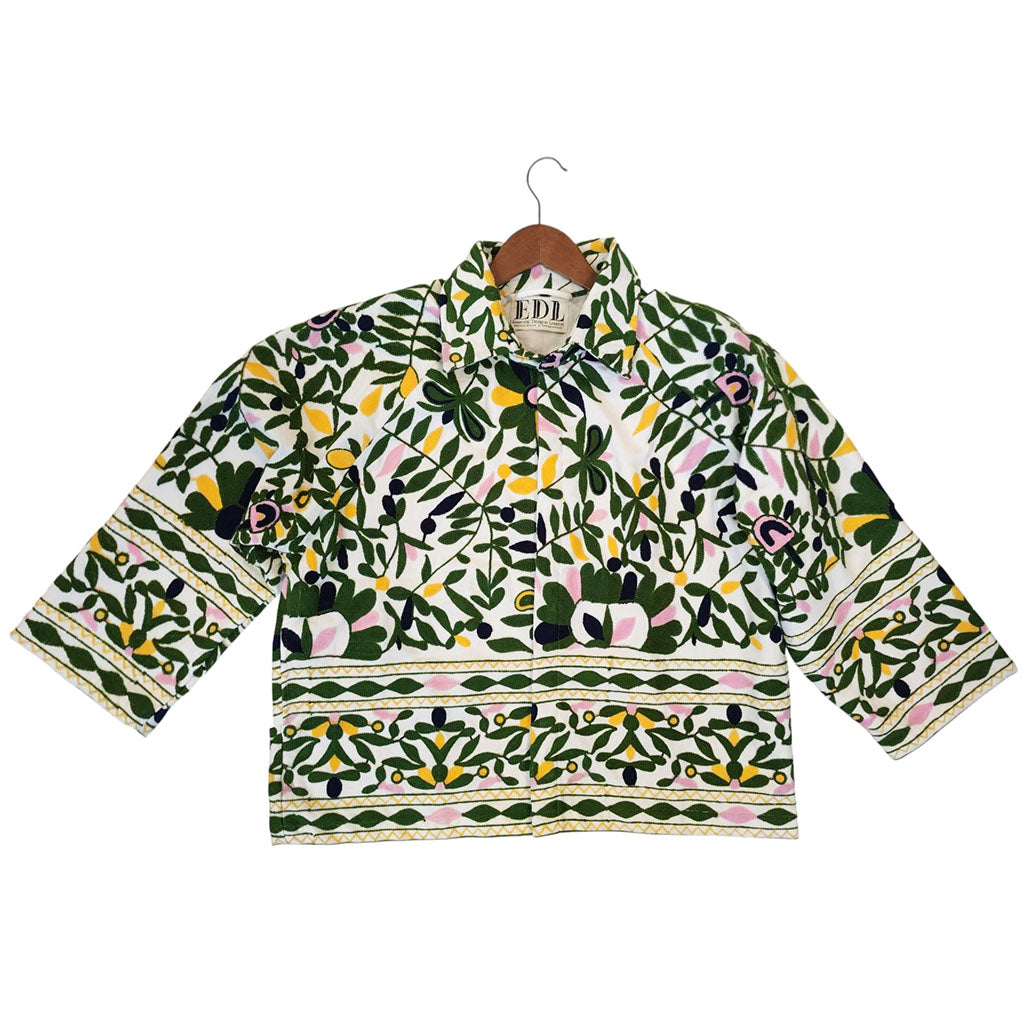 Floral patterned jacket on a hanger against a white background