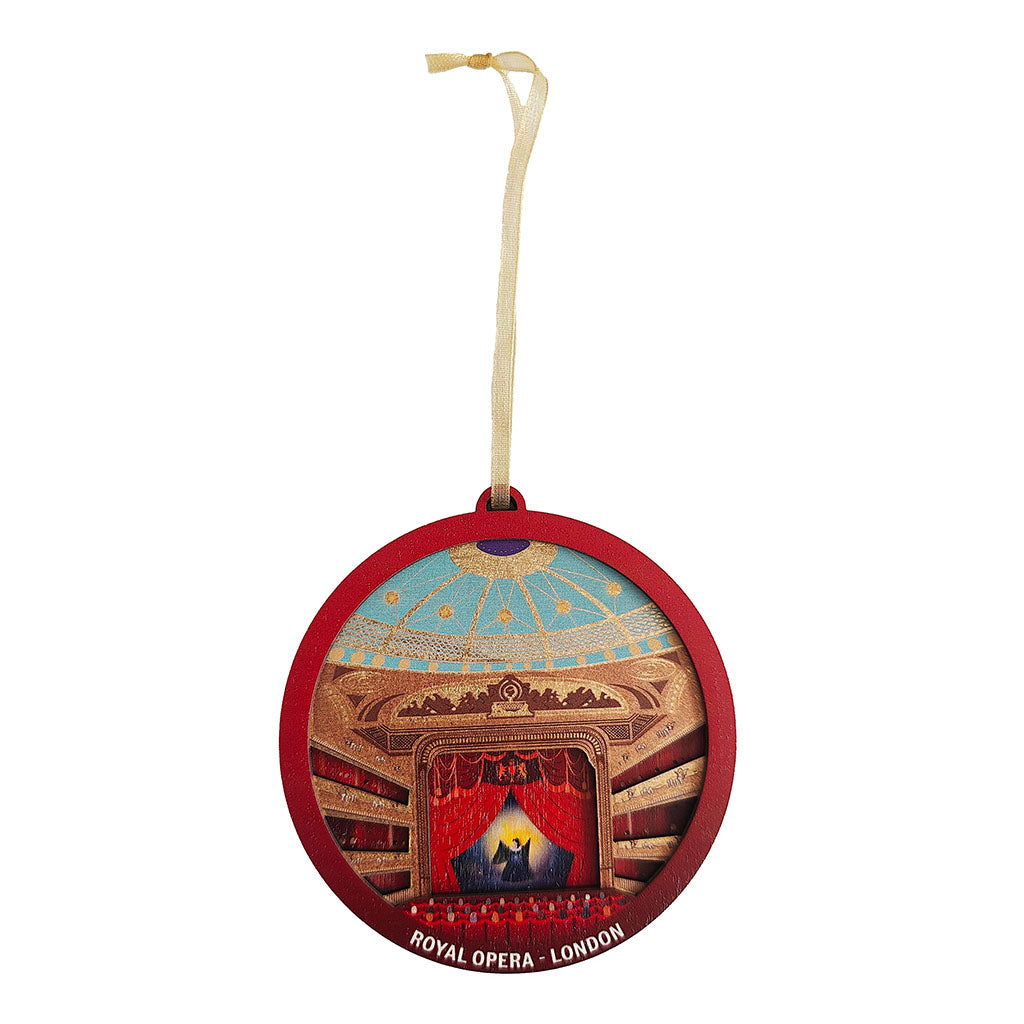 A round wooden hanging decoration depicting the interior of the Royal Opera House in London, with a red frame, illustrated stage with performer and auditorium, and a gold hanging ribbon.