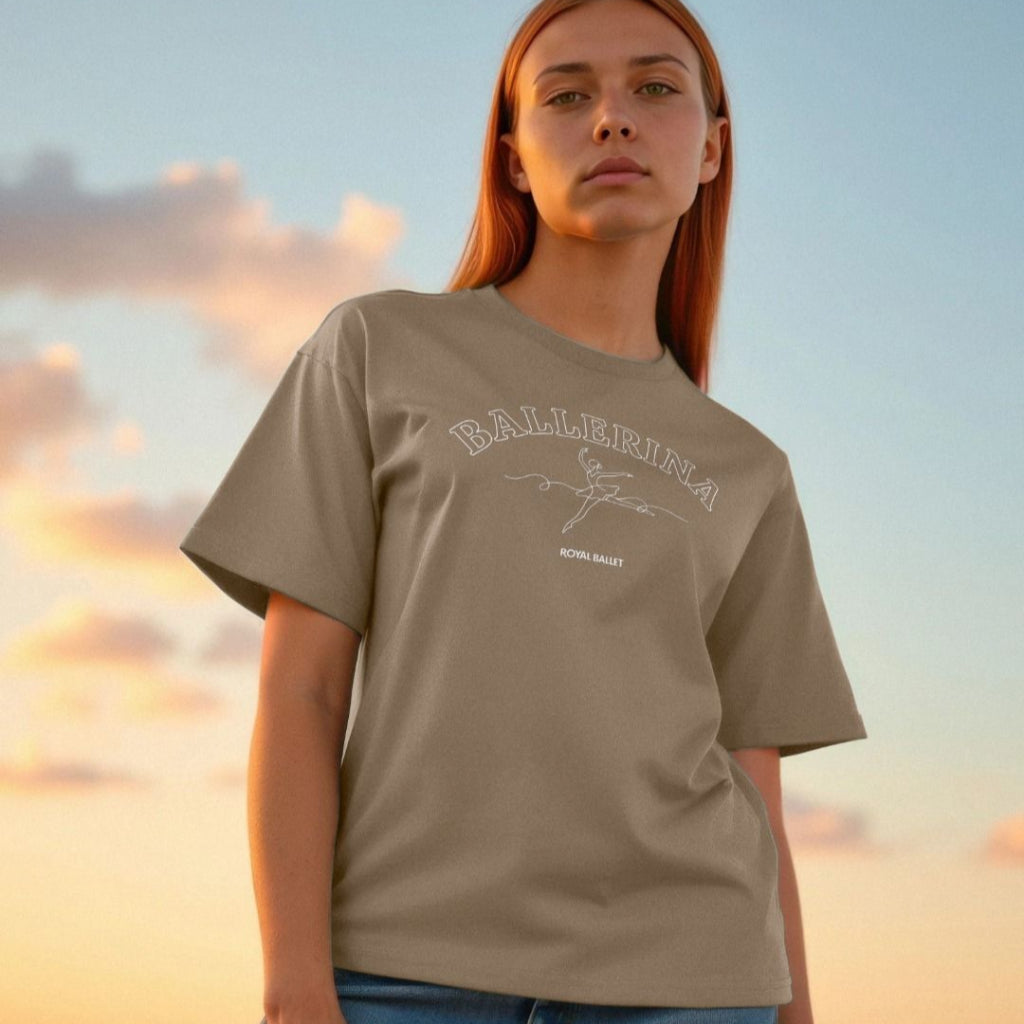 Person wearing a willow t-shirt with text Ballerina Royal Ballet and graphics against a sunset sky