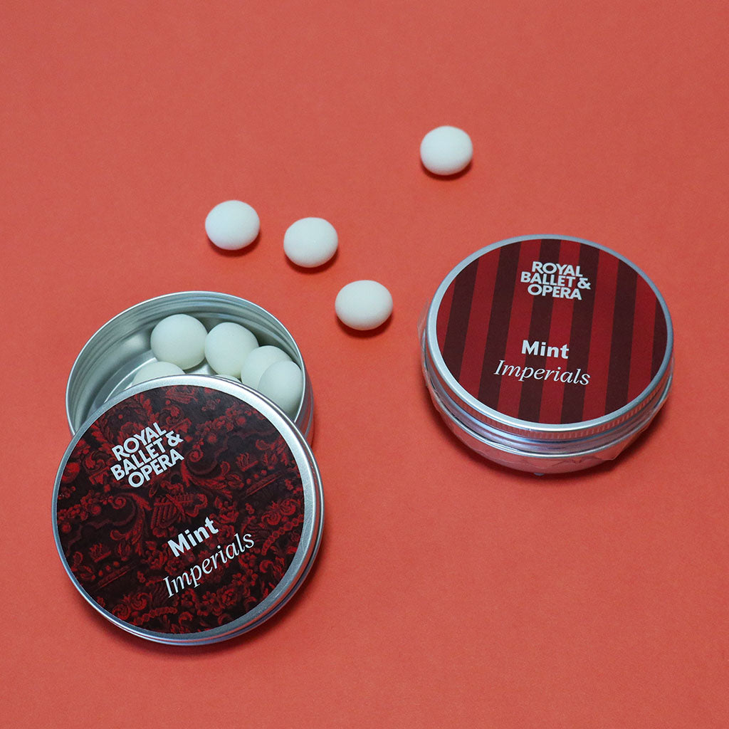 Two tins of Royal Ballet &amp; Opera Mint Imperials on a red background
