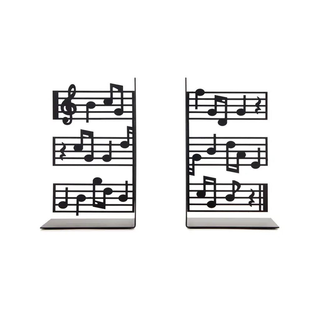 Two metal bookends with music note designs on a white background
