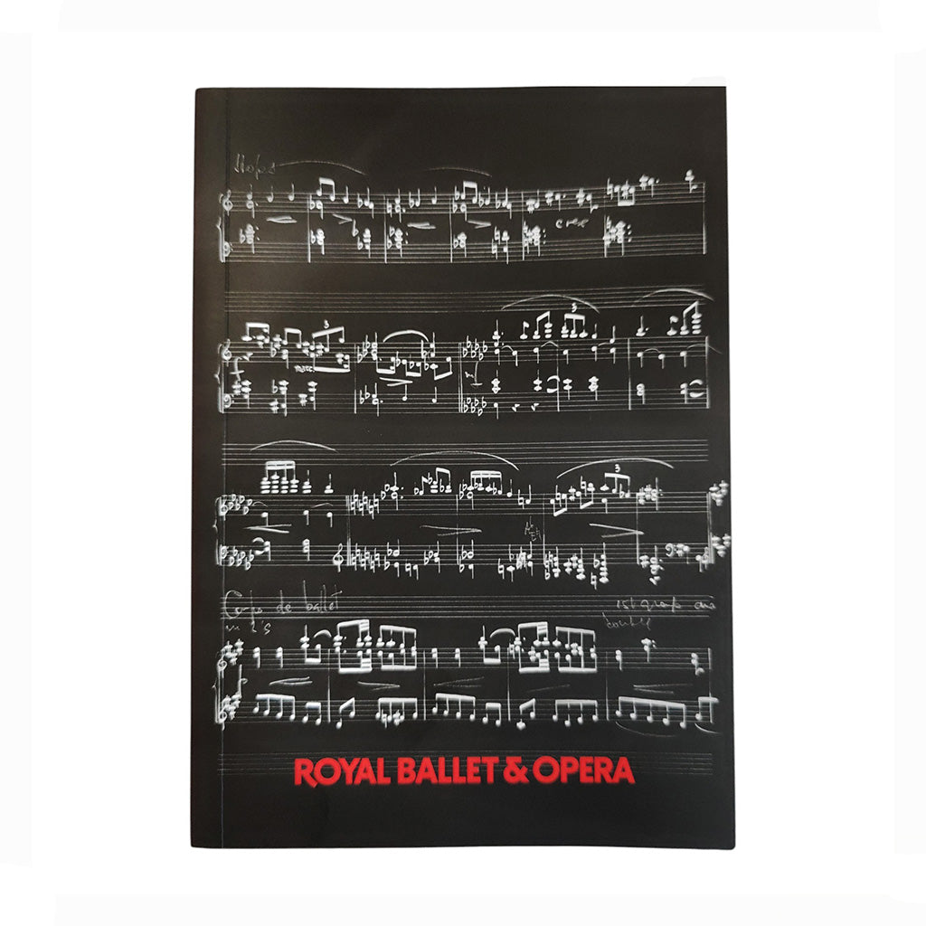 A softcover A5 notebook with red text Royal Ballet &amp; Opera, featuring a black background with white musical notation and the title in red text at the bottom.