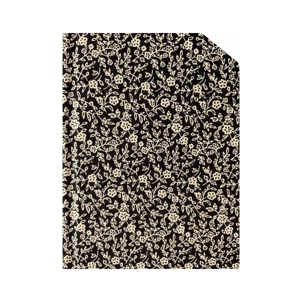 Black and Cream floral Costume Fabric covered A6 notebook on a white background