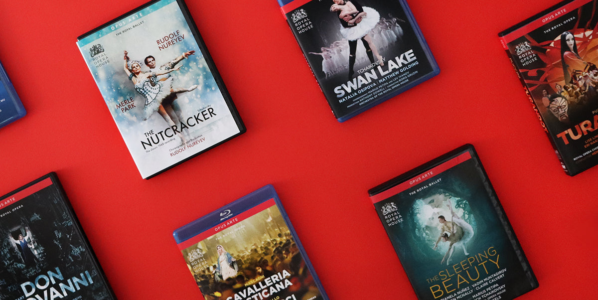 Several Blu-ray and DVDs arranged on a bright red background. Visible titles include Nutcracker, Swan Lake, Turandot, Don Giovanni, Cavalleria Rusticana, and Sleeping Beauty.