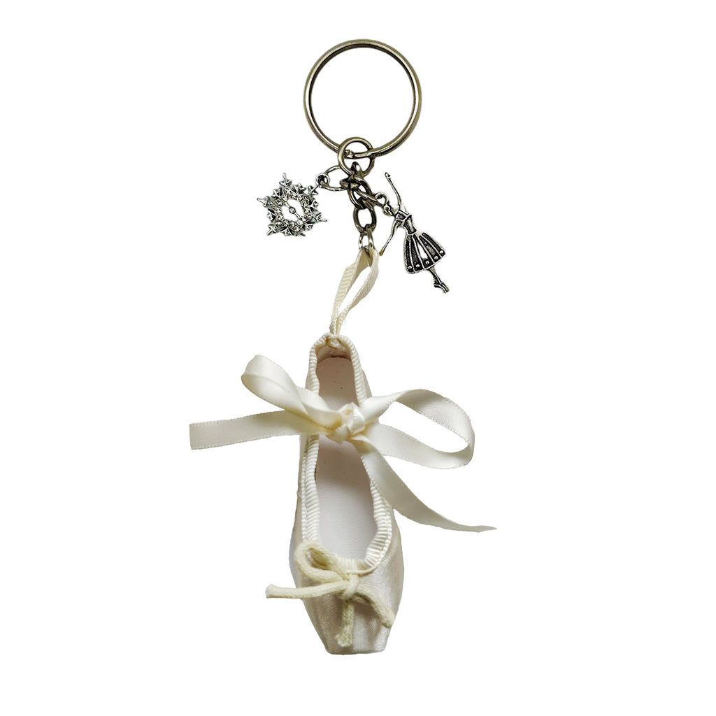 Limited Edition ballet Shoe Keying in light gold with clara and snowflake charms on a white background