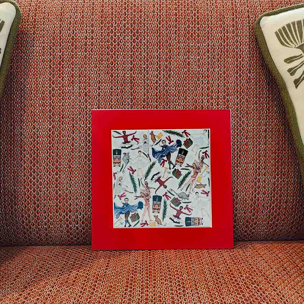 Mounted Nutcracker mini print artwork with a colourful design on a patterned sofa