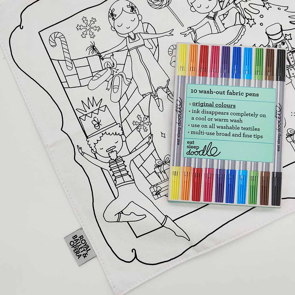 white fabric placemat with Nutcracker illustrations and colouring pens