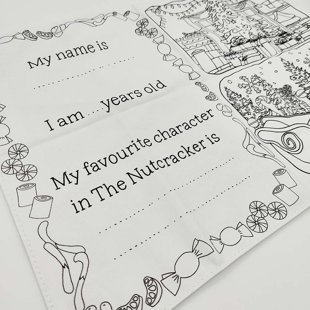 white fabric placemat with Nutcracker illustrations