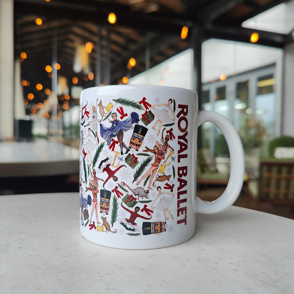 White mug with colourful illustrations of characters from 'The Nutcracker' on a white background