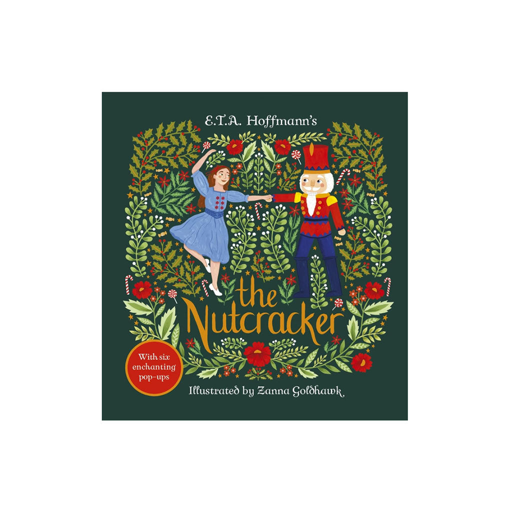 A 3D pop-up book showing a decorated Christmas tree with ornaments, stockings, gifts, and children under a star, with printed text panels on the base against a white background.