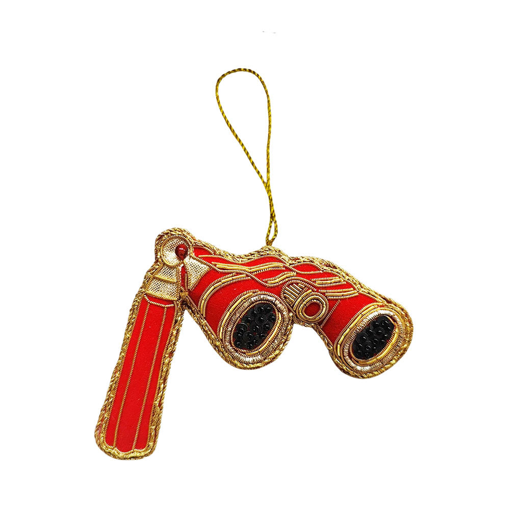 Decorative red and gold opera glass decoration on a white background