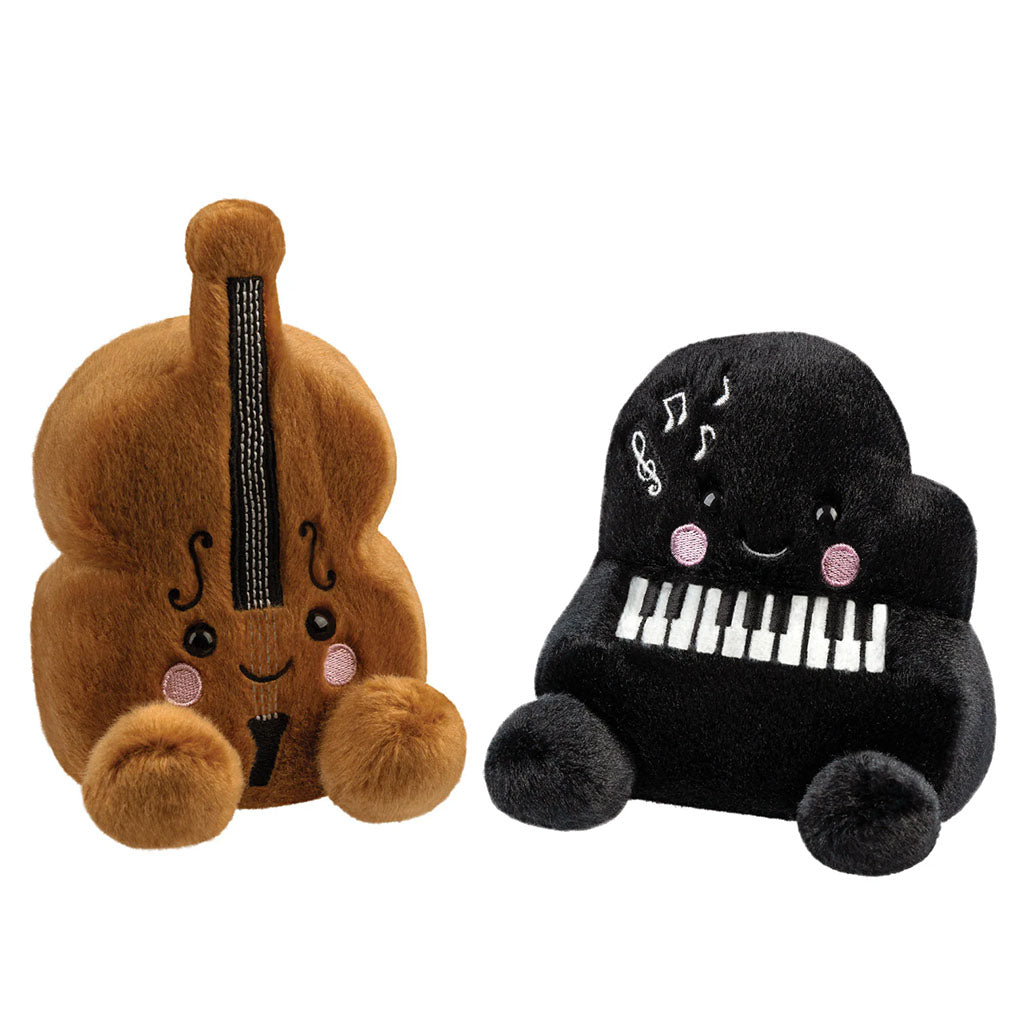 Soft toys in the shape of a violin and piano with smiley faces on a white background