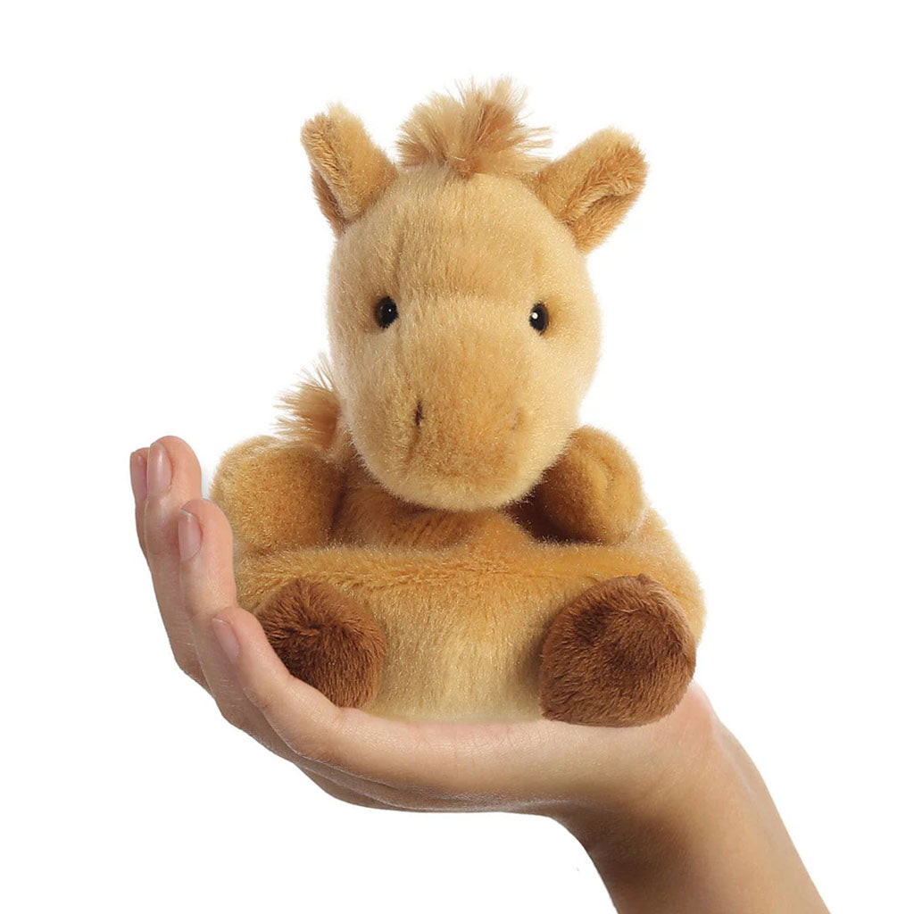 child holding a horse shape soft toy on a white background