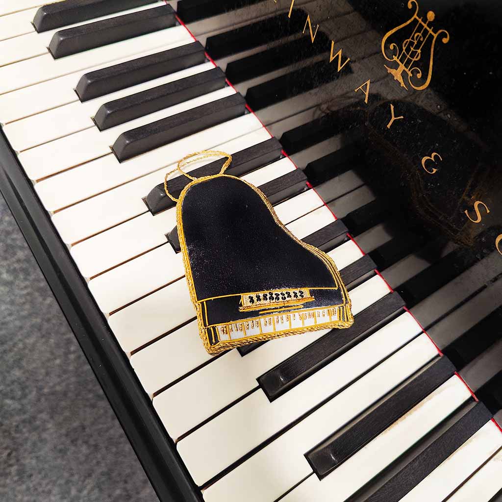 Piano keys with a decorative Grand Piano Decoration on top