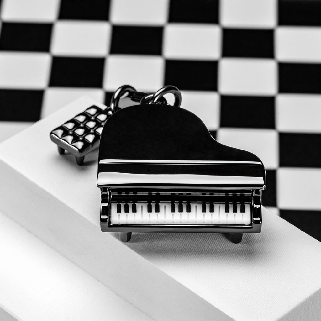 Piano-shaped keychain on a checkered background
