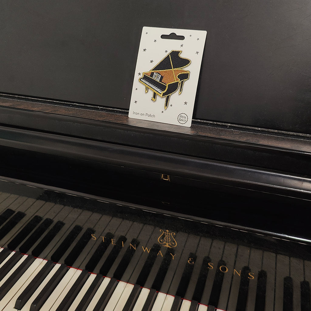 Steinway &amp; Sons piano with a patch on a card displayed on the keys