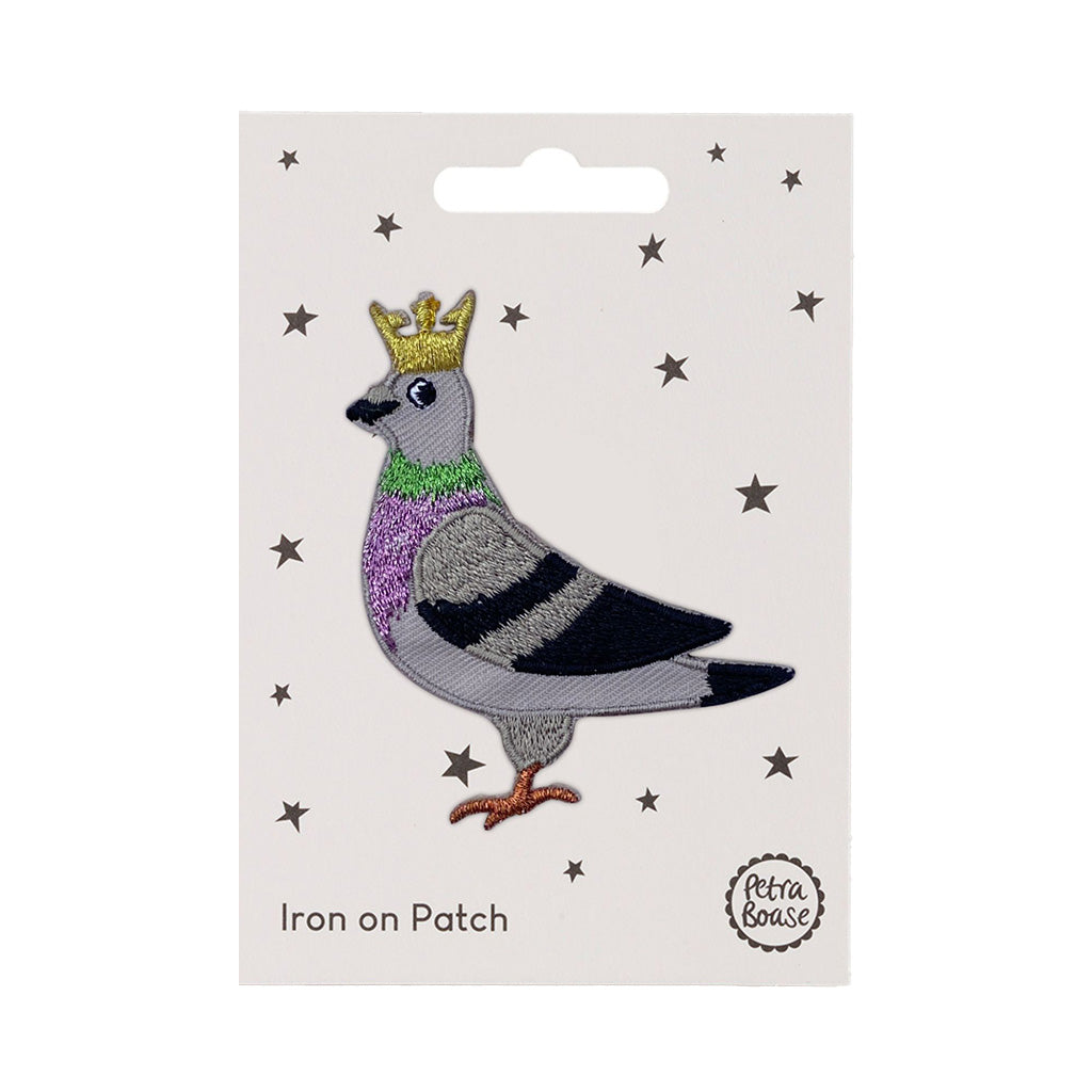 Iron on patch of a pigeon with a crown on a white card with star patterns, brand &#39;Petra Boase&#39; visible.