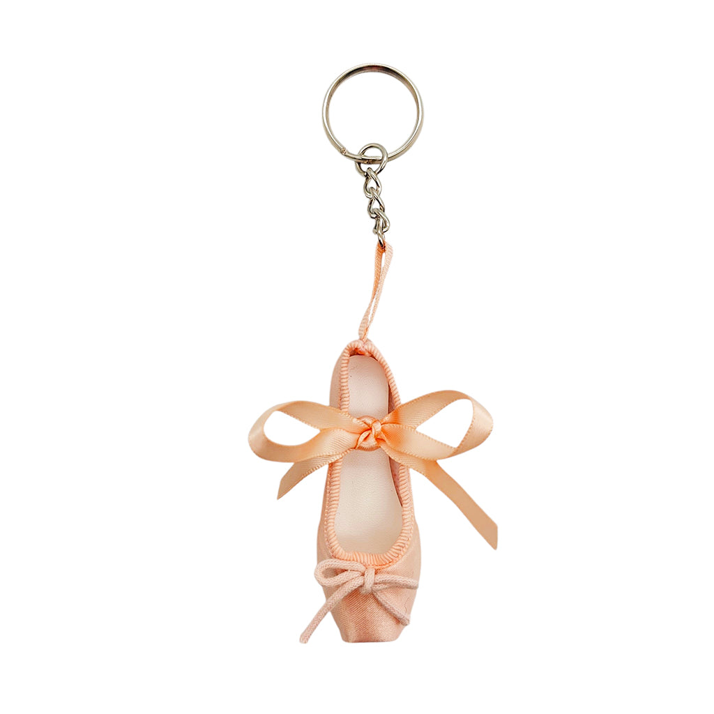 Ballet pink coloured ballet shoe keychain with a ribbon on a white background
