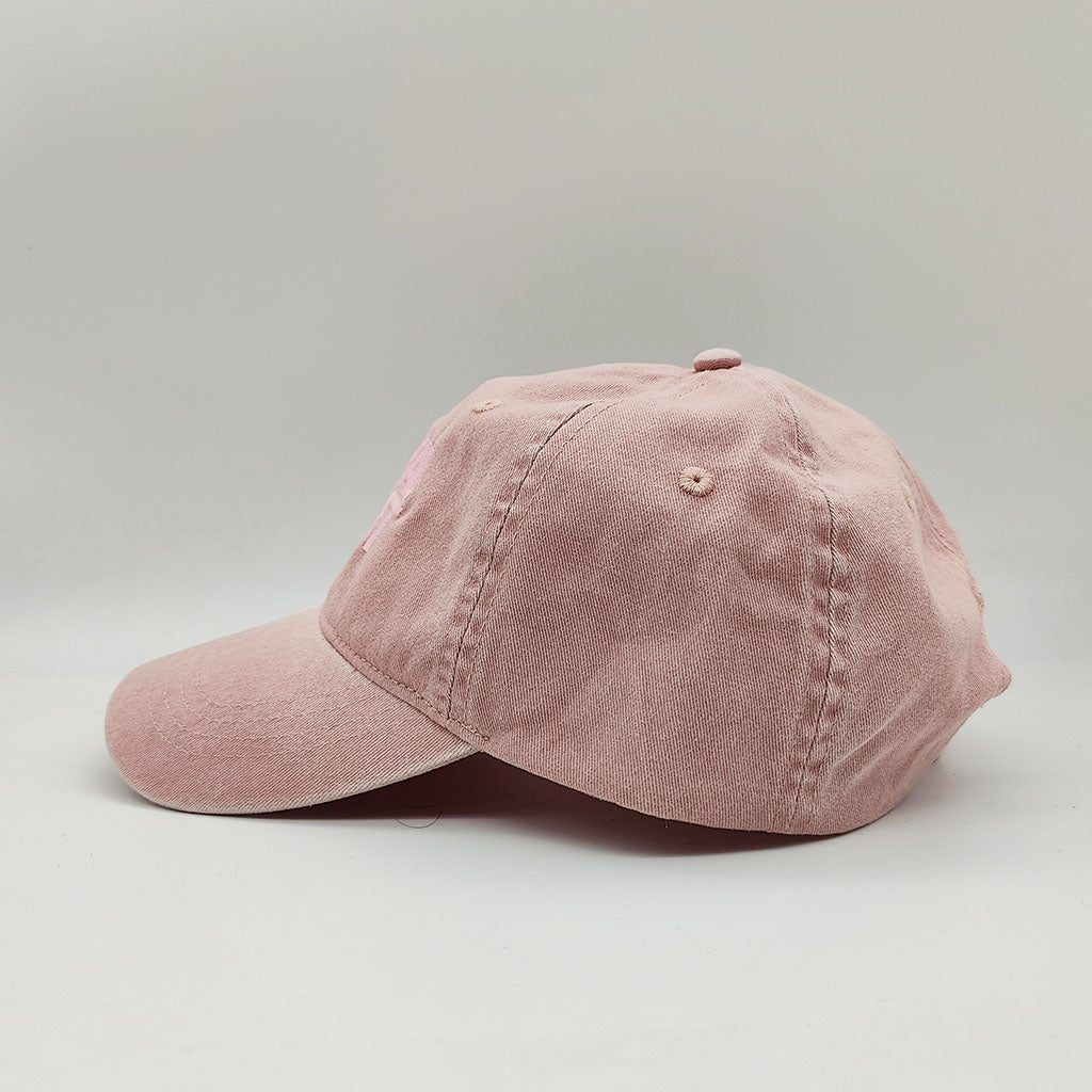 Pink baseball cap on a light gray background