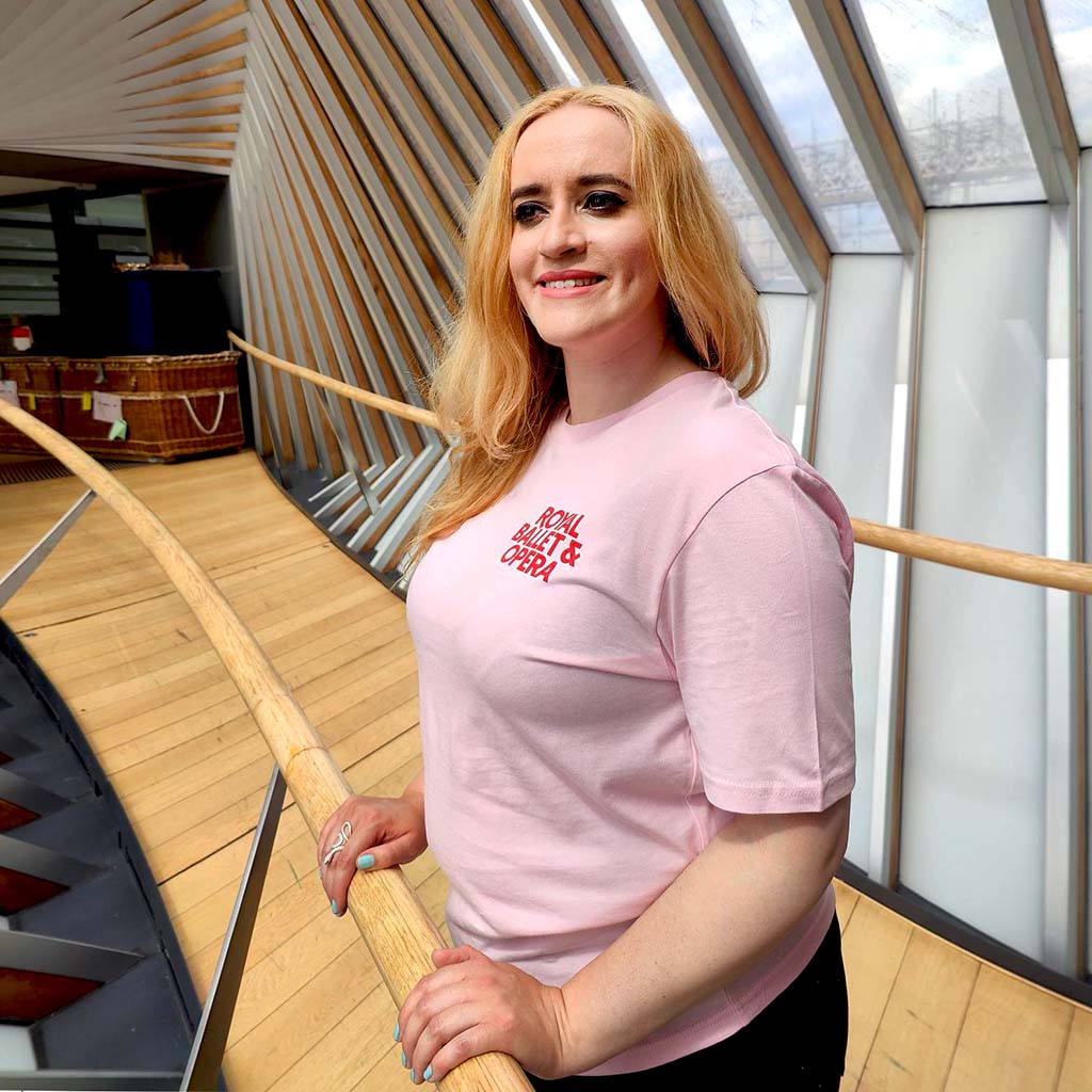 model wears RBO Pink Unisex T-Shirt on bridge of aspiration