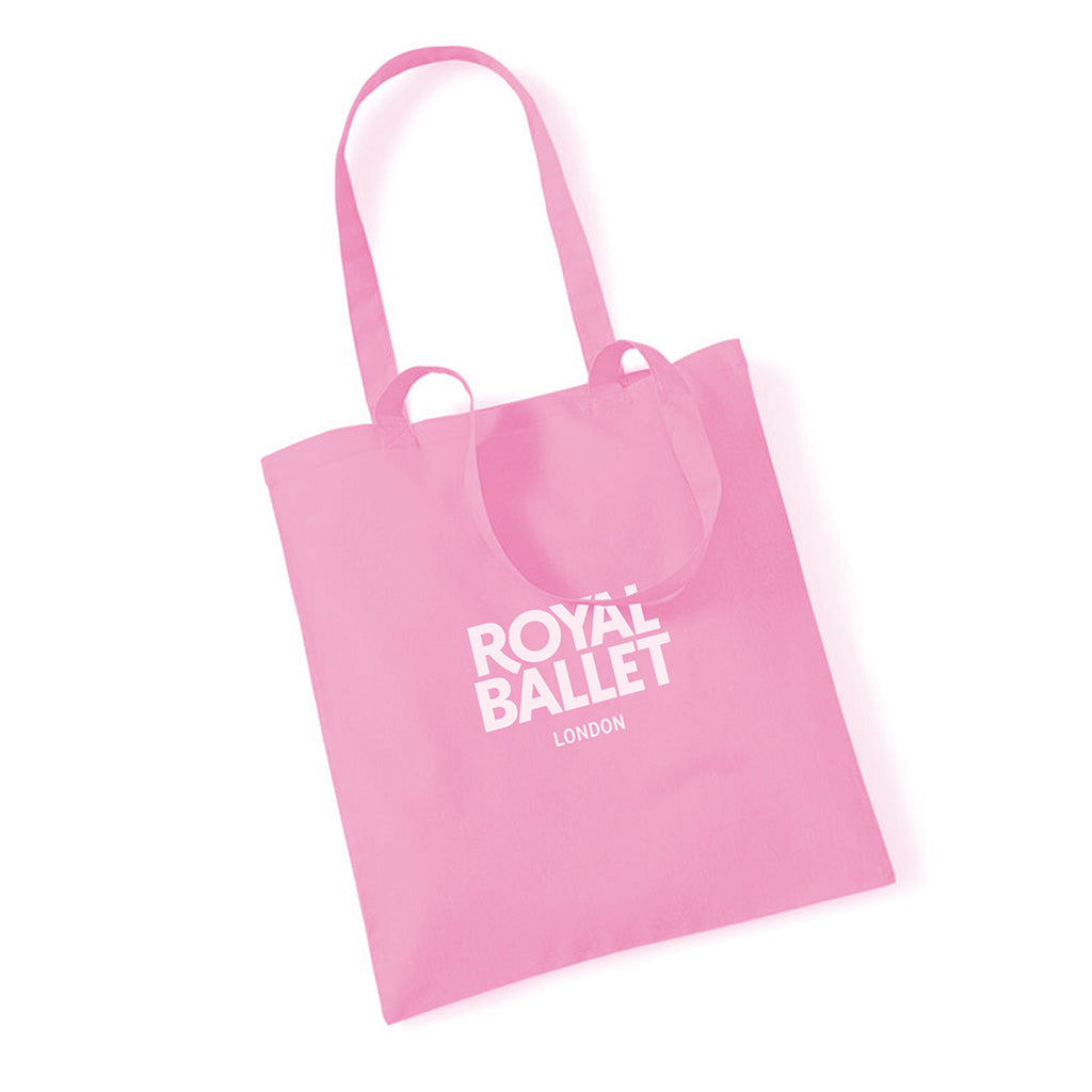 Pink tote bag with 'Royal Ballet London' text on a white background