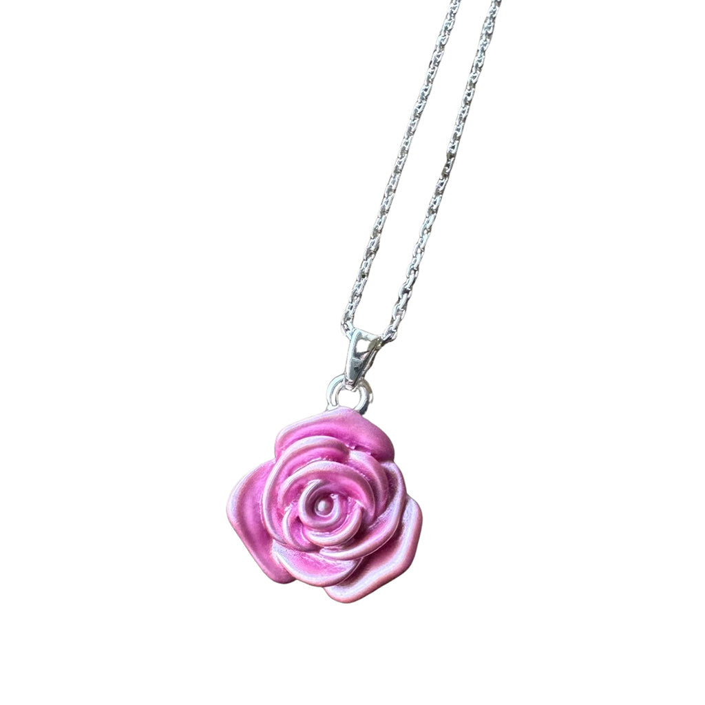 Pink rose-shaped pendant on a silver chain against a white background