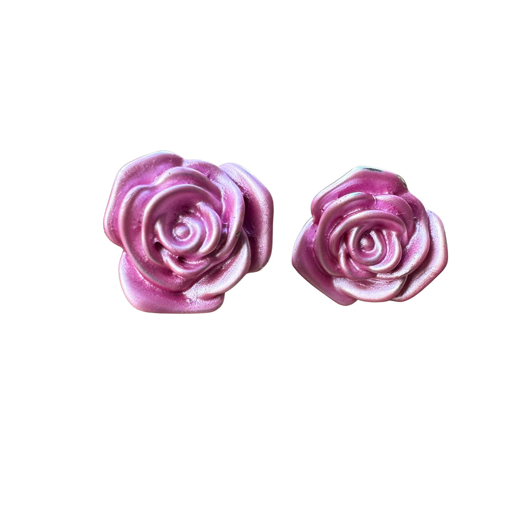 Pink rose-shaped earrings on a white background