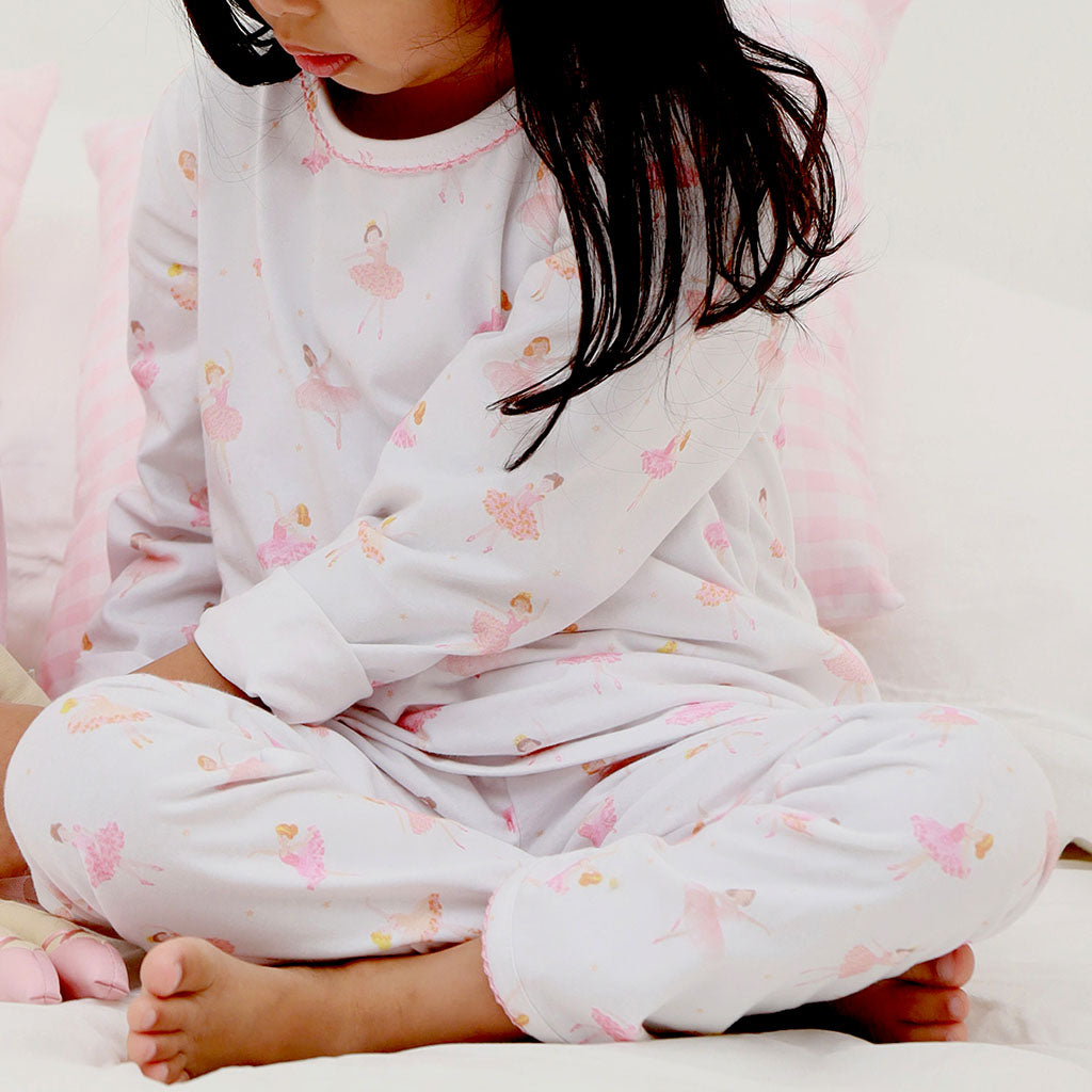 Children's pyjama set with long-sleeve top and pants featuring a ballerina pattern on a white background.