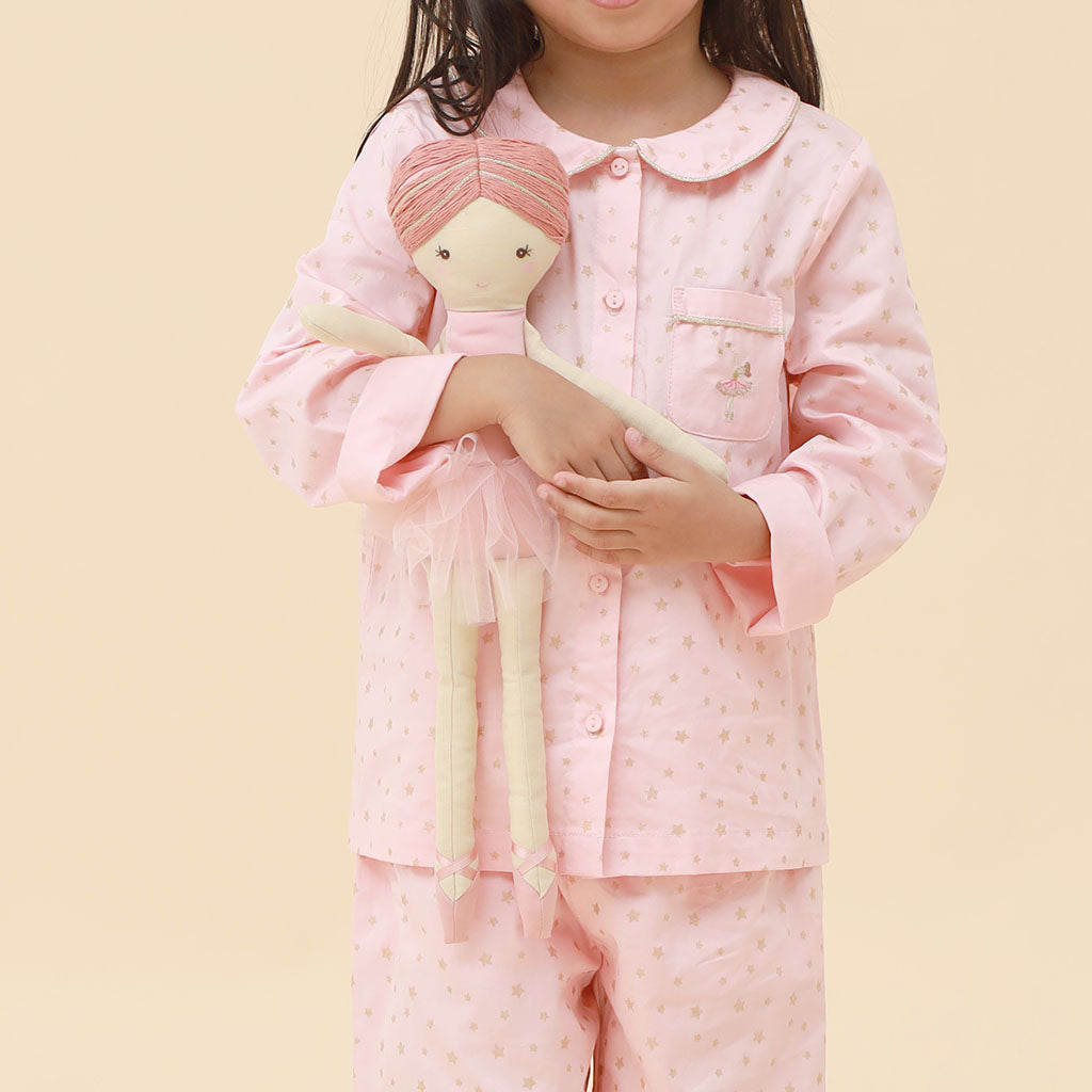 Pink children's pajama set with a subtle star pattern and ballerina pocket  a white background