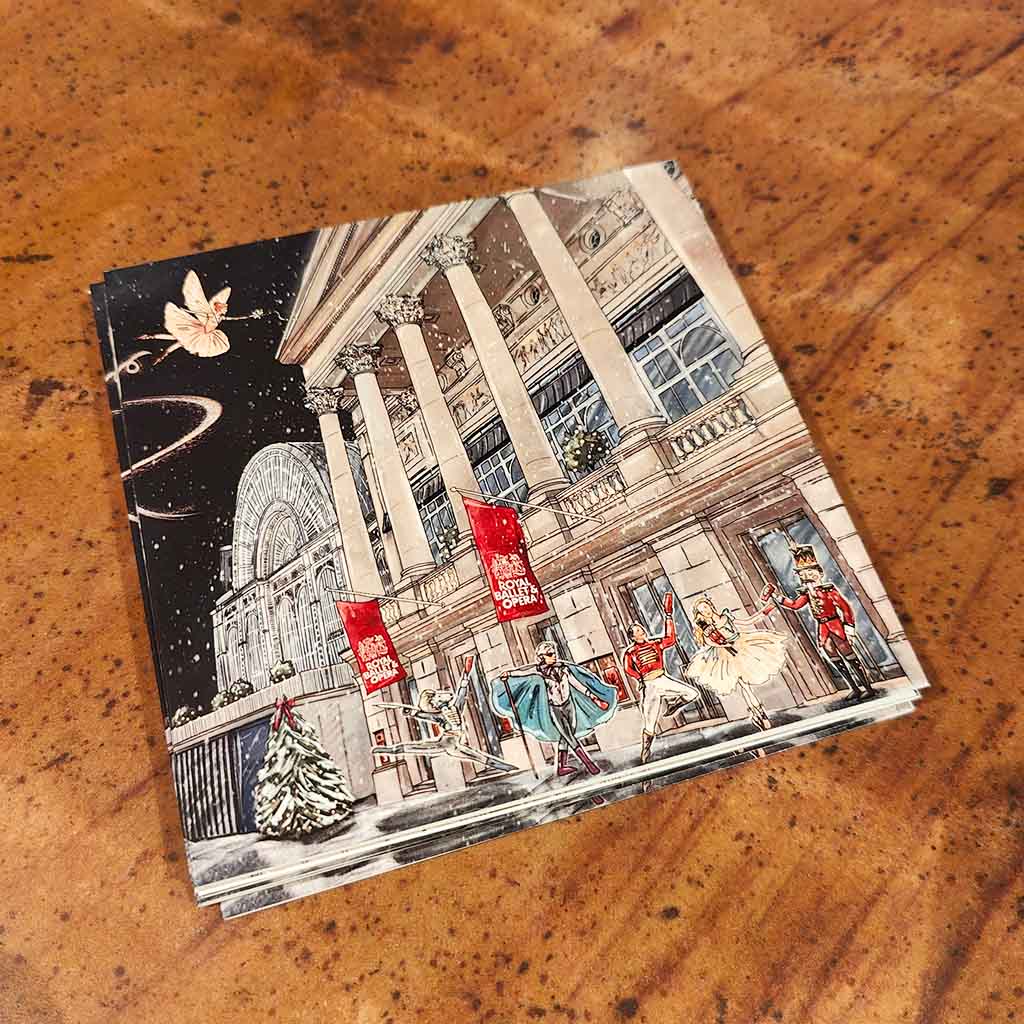 Christmas cards with the building in  a Christmas scene on a wooden surface