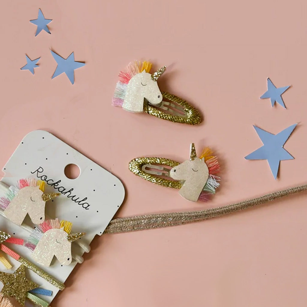 Unicorn-themed hair clips with 'Rockahula' branding on a white background