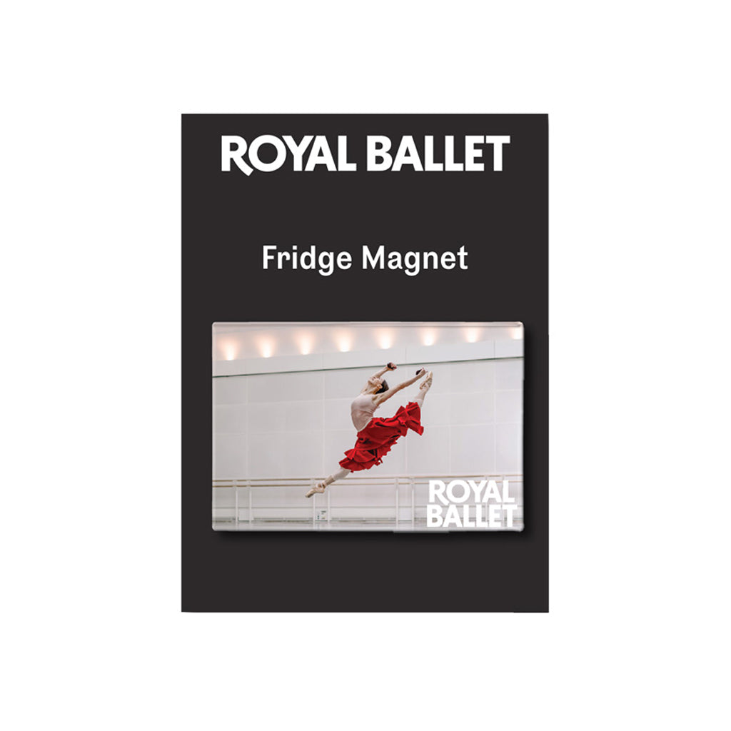 A rectangular Royal Ballet branded fridge magnet product shown on a black background card. The card reads 'ROYAL BALLET' and 'Fridge Magnet' above a photo of a ballerina in a red dress mid-leap, with the Royal Ballet logo in the lower right of the photo.
