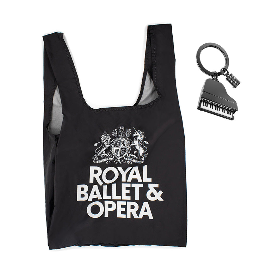 Black reusable bag with 'Royal Ballet &amp; Opera' text and a piano-shaped keyring on a white background