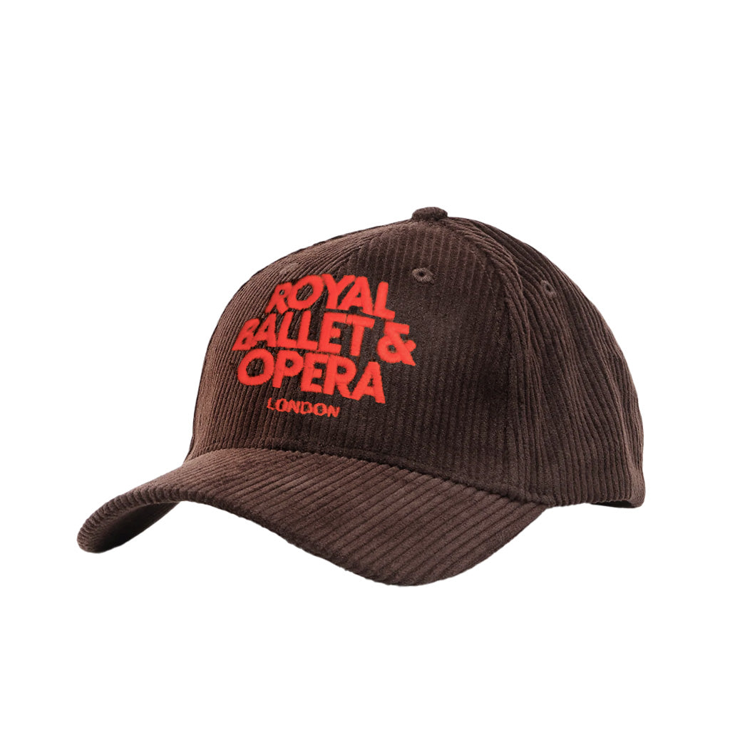 A dark brown corduroy baseball cap featuring 'ROYAL BALLET &amp; OPERA LONDON' embroidered in bright red on the front, shown against a plain white background.